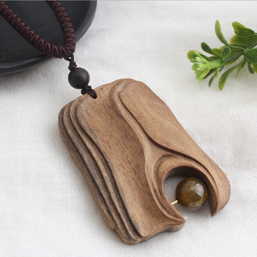 Collier avec pendentif bois et perle ambrée