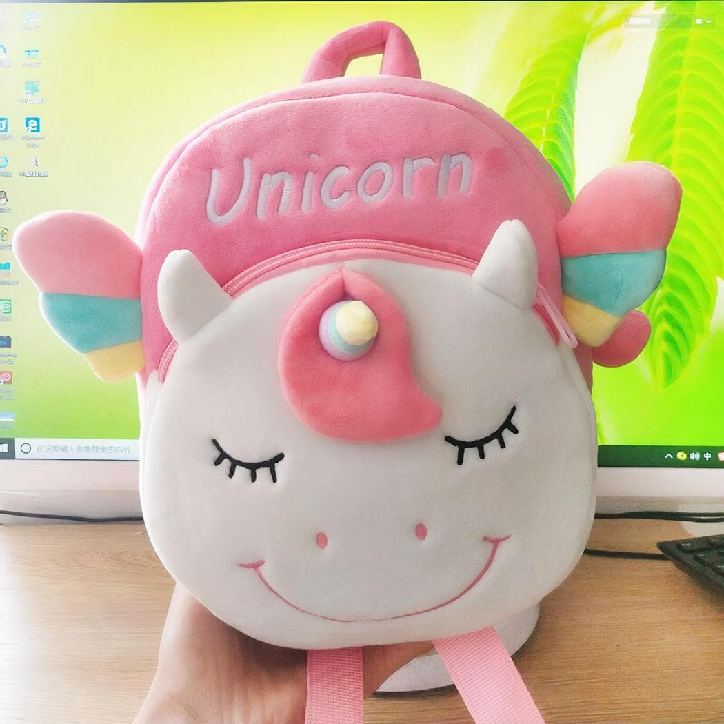 Petit sac à dos en peluche d'une licorne souriante - blanc