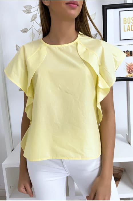 Blouse jaune à volant avec trois boutons à l'épaules